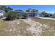 Charming single-story home with a manicured front yard and an attached one-car garage at 8906 Farmington Ln, Port Richey, FL 34668