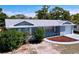 Charming single-story home with a manicured front yard and an attached one-car garage at 8906 Farmington Ln, Port Richey, FL 34668