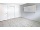 This bedroom offers tiled floors, a window for natural light, and a closet at 9402 Barrington Ln, Port Richey, FL 34668