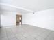 Minimalist living room featuring tile floors and an open doorway at 9402 Barrington Ln, Port Richey, FL 34668