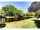 Scenic backyard featuring a serene pond surrounded by lush greenery and mature trees at 9925 Whitworth Ct, New Port Richey, FL 34655