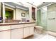 Well-maintained bathroom featuring a glass-enclosed shower and white cabinetry at 9925 Whitworth Ct, New Port Richey, FL 34655
