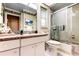 Bright bathroom featuring a shower, vanity with countertop, and tiled floors at 9925 Whitworth Ct, New Port Richey, FL 34655