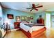 Comfortable bedroom with wood floors and a ceiling fan at 9925 Whitworth Ct, New Port Richey, FL 34655