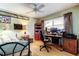 Cozy bedroom with a ceiling fan, desk, and a comfortable bed, perfect for relaxation at 9925 Whitworth Ct, New Port Richey, FL 34655