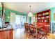 Bright dining room with a wooden table, colorful decor, and sliding glass doors to the patio at 9925 Whitworth Ct, New Port Richey, FL 34655
