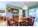 Inviting dining area with a wooden table, stylish lighting, and a view into the adjacent living spaces at 9925 Whitworth Ct, New Port Richey, FL 34655