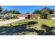 Charming single-story home with a well-maintained lawn, attached garage, and colorful landscaping at 9925 Whitworth Ct, New Port Richey, FL 34655