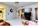 Cozy living room featuring white tile floors and open to the kitchen at 9925 Whitworth Ct, New Port Richey, FL 34655