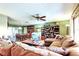 Open-concept living area leading to a dining space, with a comfortable sectional and bright, inviting atmosphere at 9925 Whitworth Ct, New Port Richey, FL 34655