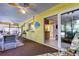 Spacious sunroom with multiple seating areas, connecting indoor comfort with outdoor views at 9925 Whitworth Ct, New Port Richey, FL 34655