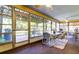 Relaxing sunroom with ample seating, views of outdoor scenery, and a bright, airy atmosphere at 9925 Whitworth Ct, New Port Richey, FL 34655