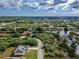 Expansive aerial view showcasing homes nestled amidst canals, trees, and manicured lawns at 10056 Lebanon Dr, Port Charlotte, FL 33981