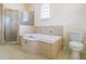Spacious bathroom featuring a large soaking tub and separate glass enclosed shower at 10056 Lebanon Dr, Port Charlotte, FL 33981
