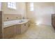 Bright bathroom featuring a large soaking tub with tile surround and floors at 10056 Lebanon Dr, Port Charlotte, FL 33981