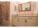 Neutral colored bathroom with vanity with drawers, framed mirror, and shower-tub combo at 10056 Lebanon Dr, Port Charlotte, FL 33981