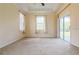 Large bedroom featuring natural light, tray ceiling, and a sliding glass door at 10056 Lebanon Dr, Port Charlotte, FL 33981
