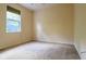 Neutral colored bedroom features carpet, a window, and natural light at 10056 Lebanon Dr, Port Charlotte, FL 33981