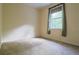 Empty carpeted bedroom with natural light and neutral colored walls at 10056 Lebanon Dr, Port Charlotte, FL 33981