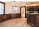 Cozy dining area with dark wood accents, decorative lighting, and tile flooring at 10056 Lebanon Dr, Port Charlotte, FL 33981