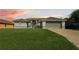 Charming single-story home with a well-maintained lawn and attached two-car garage at 10056 Lebanon Dr, Port Charlotte, FL 33981