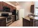 Well-equipped kitchen featuring stainless steel appliances, granite countertops, and dark cabinetry at 10056 Lebanon Dr, Port Charlotte, FL 33981