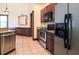 Modern kitchen with stainless steel appliances, dark wood cabinets, and tile flooring at 10056 Lebanon Dr, Port Charlotte, FL 33981