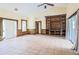 Expansive living room featuring vaulted ceilings, built-in shelving, and tile flooring at 10056 Lebanon Dr, Port Charlotte, FL 33981