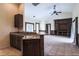 Open floor plan with tile flooring, built-in shelving, and a kitchen bar, perfect for entertaining at 10056 Lebanon Dr, Port Charlotte, FL 33981