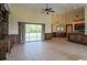 Spacious living room with tile flooring, built-in shelves, and access to the backyard at 10056 Lebanon Dr, Port Charlotte, FL 33981