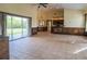 Bright and open living room with tile flooring, built-in shelving, and a sliding glass door at 10056 Lebanon Dr, Port Charlotte, FL 33981