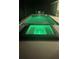 Night view of a private pool and spa with vibrant underwater lighting at 10056 Lebanon Dr, Port Charlotte, FL 33981
