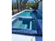 Inviting screened-in pool and spa with bright blue tile at 10056 Lebanon Dr, Port Charlotte, FL 33981