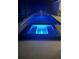 Illuminated in-ground pool and hot tub with stylish chairs and table at 10056 Lebanon Dr, Port Charlotte, FL 33981