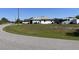 Exterior rear view of the house with a lush green backyard at 10056 Lebanon Dr, Port Charlotte, FL 33981