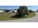 Corner vacant lot ready for construction, adorned with palm trees and greenery at 10056 Lebanon Dr, Port Charlotte, FL 33981