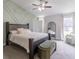 Comfortable bedroom with decorative wall, ceiling fan, and ample natural light at 10114 Briar Cir, Hudson, FL 34667
