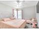 Bedroom with bed and decorative headboard, and sitting area at 10114 Briar Cir, Hudson, FL 34667