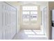 Bright foyer featuring a large window, tiled floor, and closet space at 10114 Briar Cir, Hudson, FL 34667