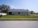 Side view of a cozy home with a spacious backyard, and a well-manicured lawn at 10114 Briar Cir, Hudson, FL 34667