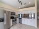 Modern kitchen with stainless steel appliances and white cabinetry at 10114 Briar Cir, Hudson, FL 34667