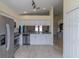 Modern kitchen with stainless steel appliances and white cabinetry at 10114 Briar Cir, Hudson, FL 34667