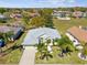 An aerial view displays the home's roof, lawn, and neighborhood at 10285 Velvetseed Cir, Spring Hill, FL 34608