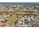Wide aerial view of a residential neighborhood surrounded by greenspace in a planned community at 10285 Velvetseed Cir, Spring Hill, FL 34608