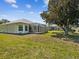The backyard has a screen-enclosed patio and lawn at 10285 Velvetseed Cir, Spring Hill, FL 34608