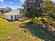 The backyard has a lawn and mature tree at 10285 Velvetseed Cir, Spring Hill, FL 34608