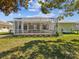 The backyard has a screen-enclosed patio and lawn at 10285 Velvetseed Cir, Spring Hill, FL 34608