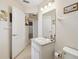 Bathroom featuring a vanity sink, white cabinets and bright lighting at 10285 Velvetseed Cir, Spring Hill, FL 34608