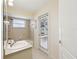 Bathroom with shower-tub combination, exterior access door and natural light at 10285 Velvetseed Cir, Spring Hill, FL 34608