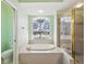 Bathroom features soaking tub, glass shower, and toilet at 10285 Velvetseed Cir, Spring Hill, FL 34608
